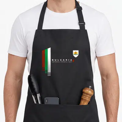 Bulgaria pride apron - Stylized flag and coat of arms with BULGARIA NATIONAL DRINKING TEAM text and red mug — shown on a black cotton canvas apron against a white background