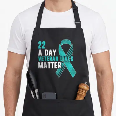 Live ptsd awareness apron - Distressed teal ribbon and stacked text 22 a day veteran lives matter — shown on a black cotton canvas apron against a white background