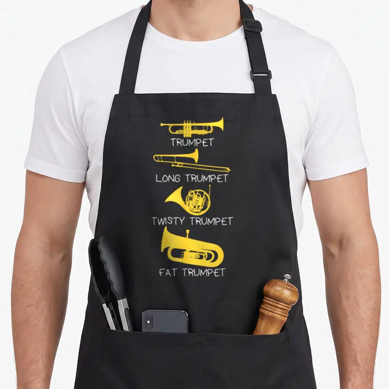 Marching trumpet apron - Four yellow brass instruments labeled trumpet long twisty and fat in white text — shown on a black cotton canvas apron against a white background