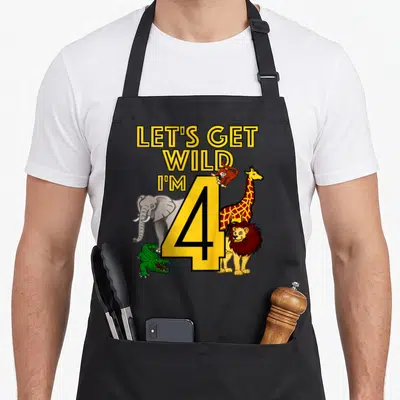 Jungle animal birthday apron - Yellow number 4 with elephant, giraffe, lion, crocodile, and monkey surrounding stacked — shown on a black cotton canvas apron against a white background