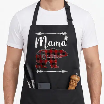 Mama bear mother's day aprons - Mama Bear text over buffalo plaid bear silhouette with two arrows — shown on a black cotton canvas apron against a white background