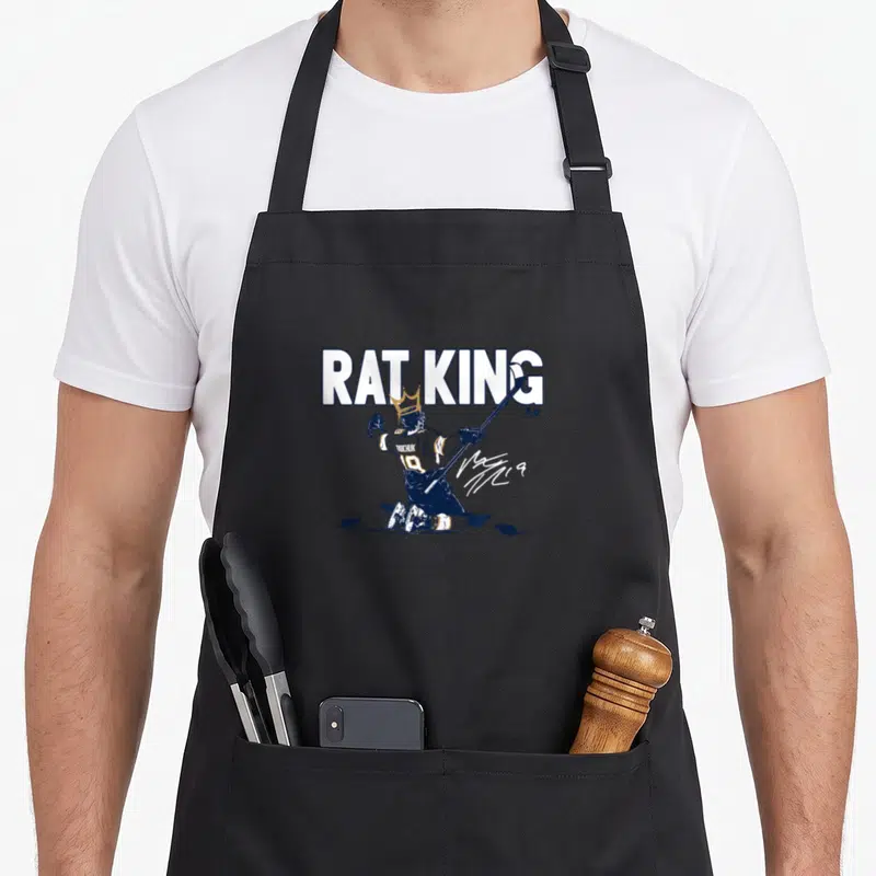 Matthew king apron - Rat King text above kneeling hockey player with crown and rats in navy white gold line art — shown on a black cotton canvas apron against a white background