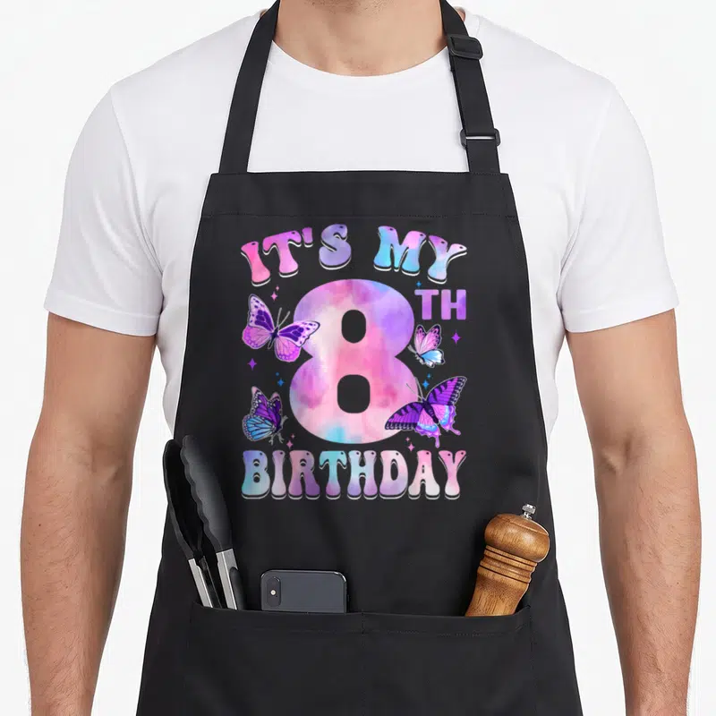 8th butterfly aprons - IT'S MY 8TH BIRTHDAY text with number 8 and pink purple blue butterflies — shown on a black cotton canvas apron against a white background