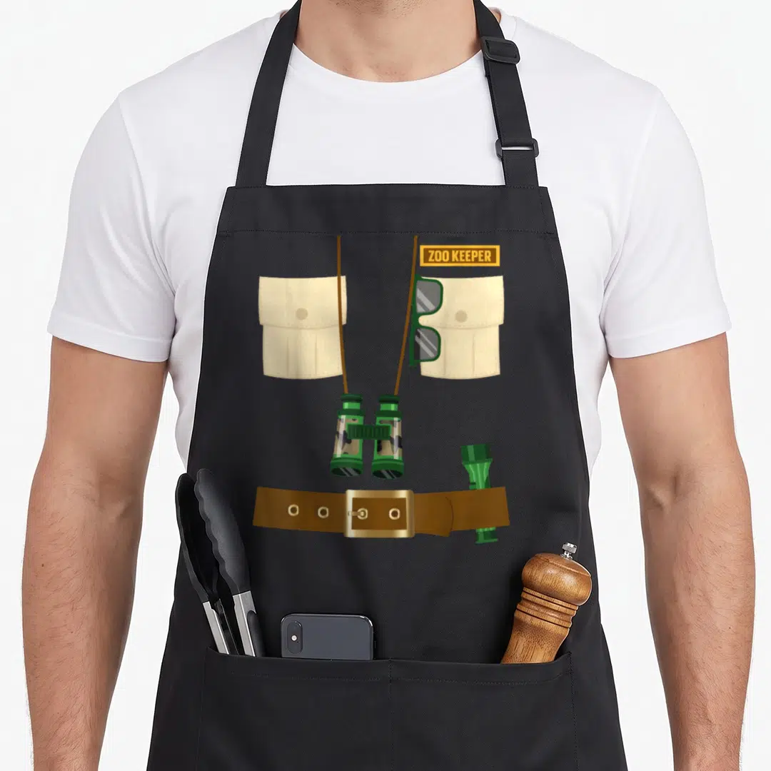 Zoo halloween apron - Illustrated zoo keeper gear with khaki pockets, green binoculars, and brown belt — shown on a black cotton canvas apron against a white background