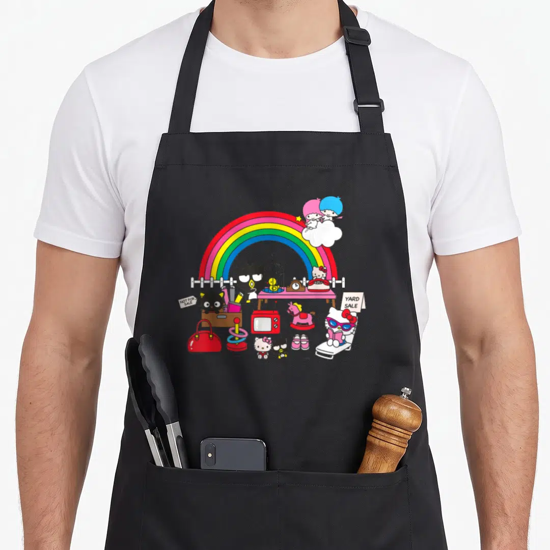 Yard hello apron - Hello Kitty characters under a rainbow with yard sale signs and vintage toys in pink, red, blue — shown on a black cotton canvas apron against a white background
