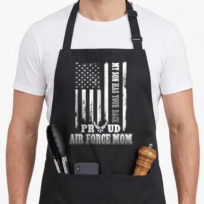 Force mom and son aprons - Distressed white USA flag with vertical MY SON HAS YOUR BACK text and Air Force symbol — shown on a black cotton canvas apron against a white background