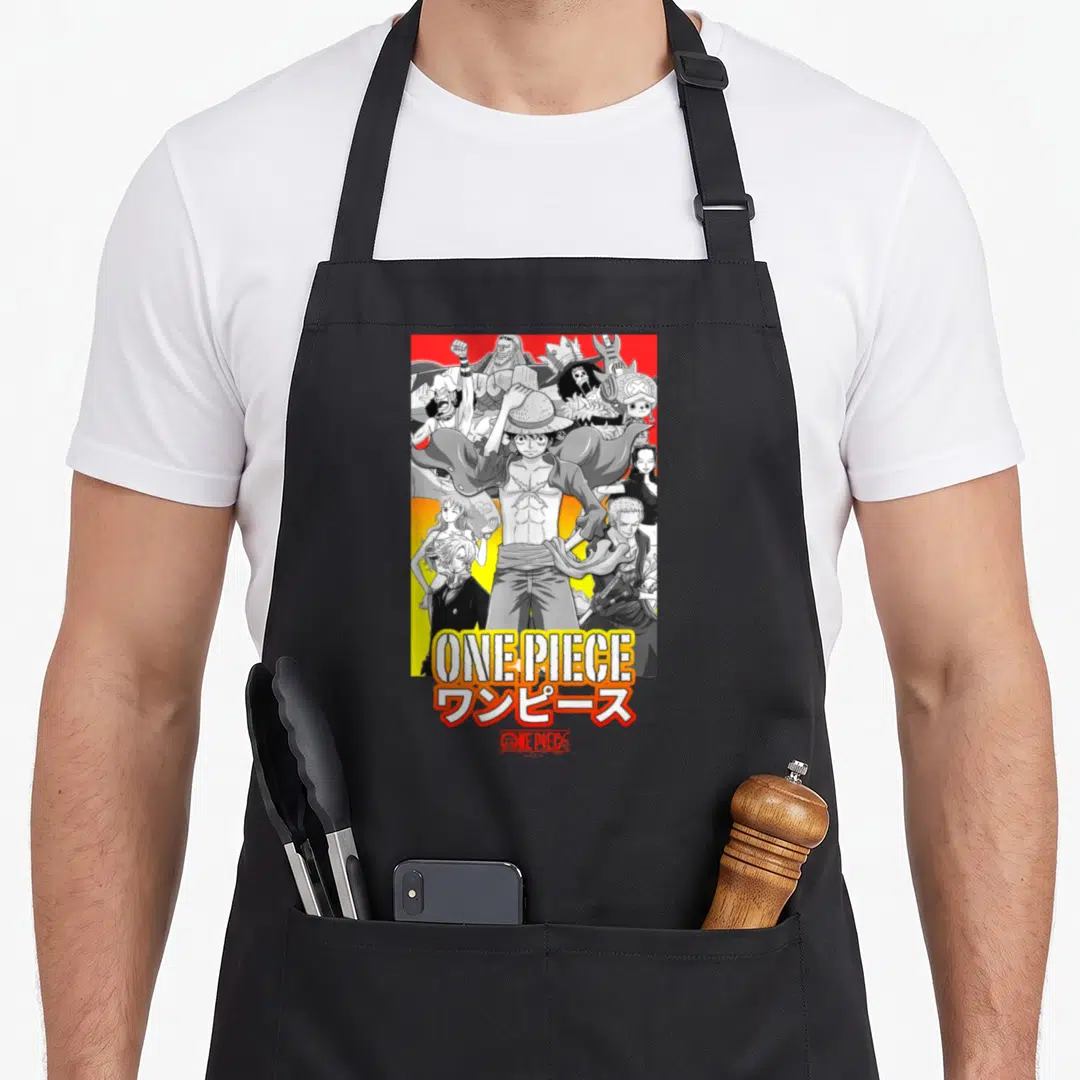 Collage anime character apron - Luffy surrounded by crew with ONE PIECE text and Japanese characters in grey yellow red — shown on a black cotton canvas apron against a white background