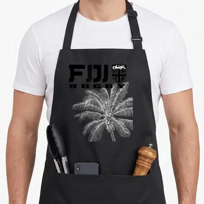 Rugby fiji apron - FIJI RUGBY text, coat of arms, and white dotted palm tree graphic — shown on a black cotton canvas apron against a white background