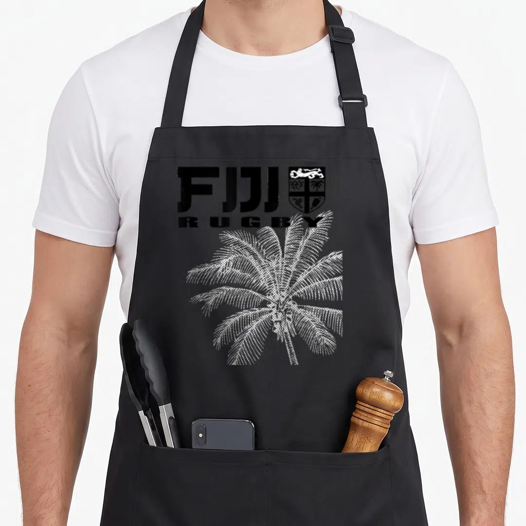 Rugby fiji apron - FIJI RUGBY text, coat of arms, and white dotted palm tree graphic — shown on a black cotton canvas apron against a white background