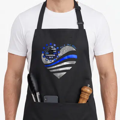 Sunflower police apron - Heart shape with blue line and Back The Blue text — shown on a black cotton canvas apron against a white background