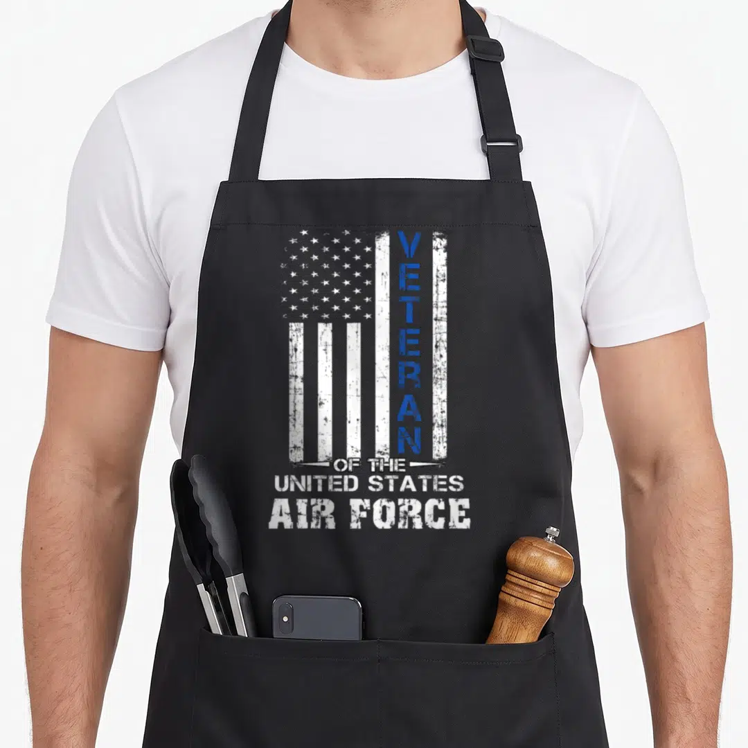 Veteran us aprons - Distressed USA flag with vertical blue VETERAN text and horizontal United States Air Force lettering — shown on a black cotton canvas apron against a white background
