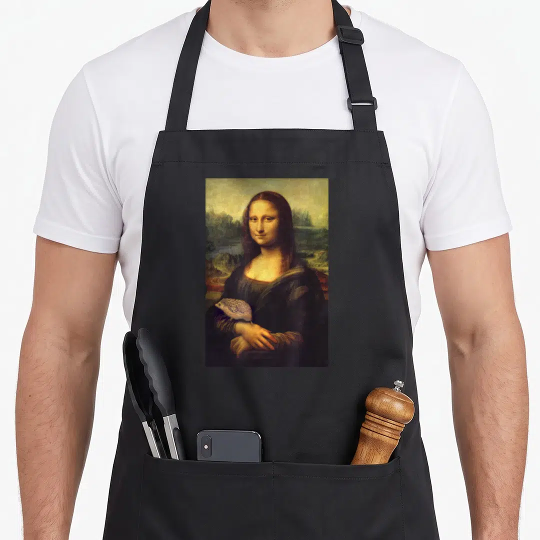 Mona funny hedgehog apron - Woman holding hedgehog in landscape painting style with brown and gold tones — shown on a black cotton canvas apron against a white background