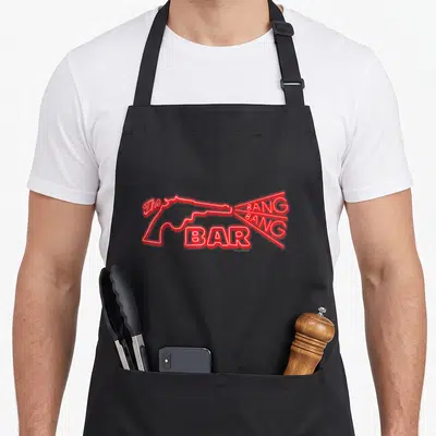 Bang twin peaks apron - Red neon outline of a gun with The Bang Bang Bar text inside muzzle flash — shown on a black cotton canvas apron against a white background