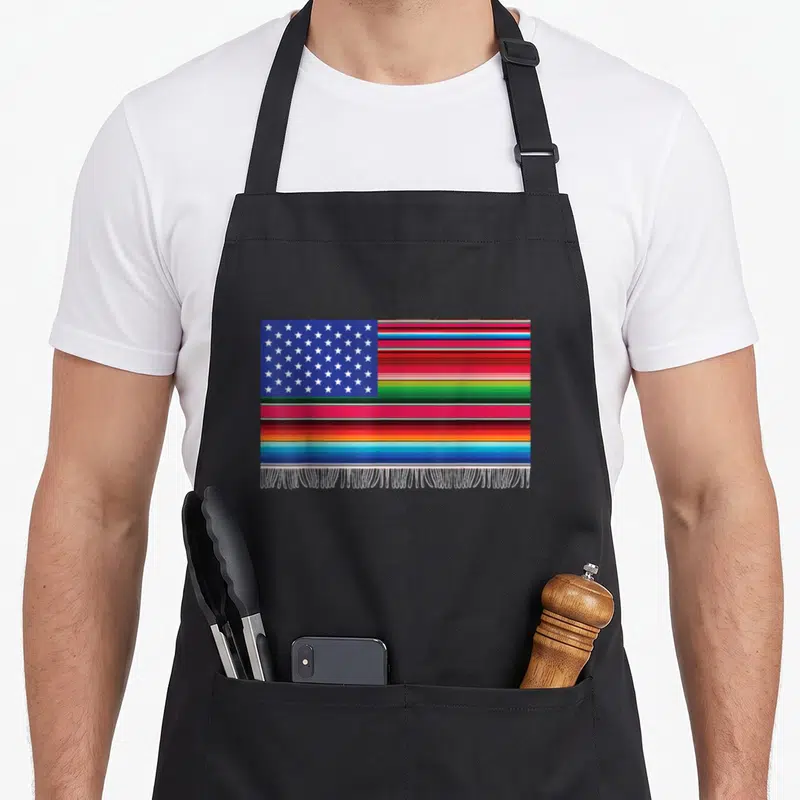 Mayo american flag apron - Rectangular flag with blue star field, multicolored stripes, and white fringe on canvas — shown on a black cotton canvas apron against a white background
