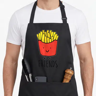 Friend french apron - Cartoon red french fry container with face and legs above the word FRIENDS in black — shown on a black cotton canvas apron against a white background
