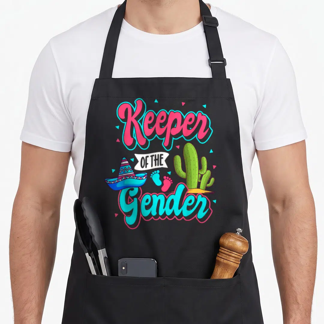 Gender mexican apron - Keeper OF THE Gender text with sombrero cactus and footprints — shown on a black cotton canvas apron against a white background