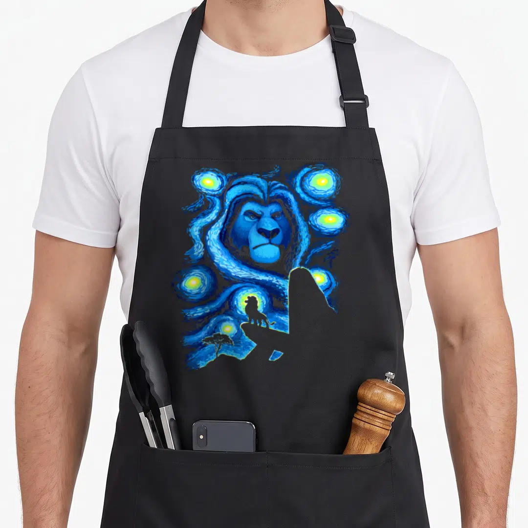 Mufasa pride apron - Realistic blue lion head in swirling blue sky with yellow stars and small tree silhouette — shown on a black cotton canvas apron against a white background