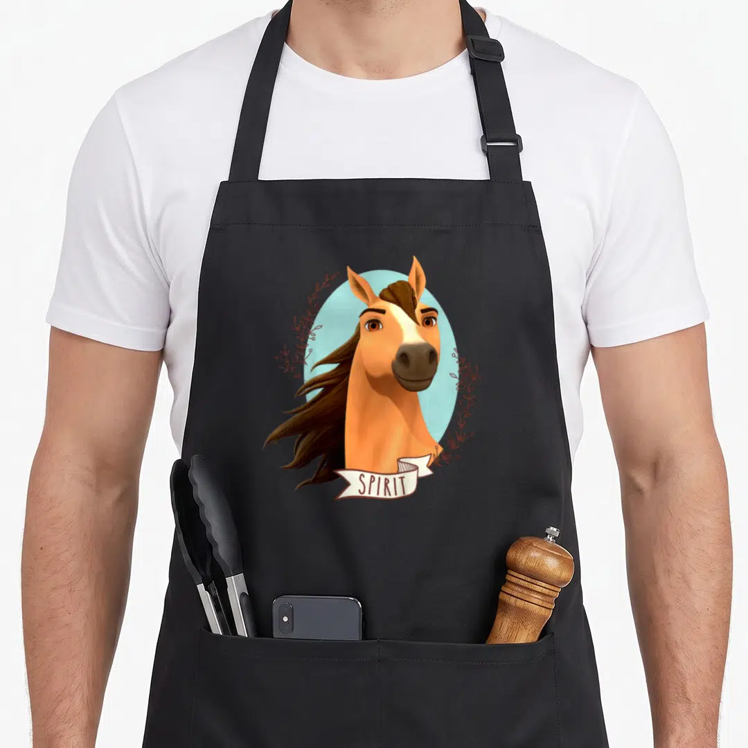 Riding free novelty apron - Tan horse head on blue circle with SPIRIT banner and brown leaf frames — shown on a black cotton canvas apron against a white background