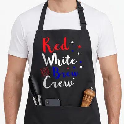 Crew 4th of july apron - Red white and brew crew text with eight scattered stars in red white and blue typography — shown on a black cotton canvas apron against a white background