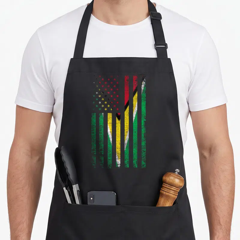 Guyana pride american flag apron - Vertical distressed flag stripes in red yellow green black with multicolored stars — shown on a black cotton canvas apron against a white background