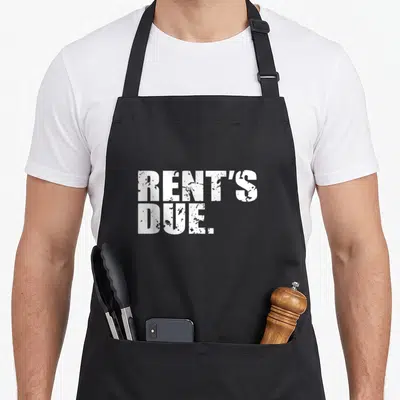 Due distressed apron - White RENT'S DUE. text on black background — shown on a black cotton canvas apron against a white background