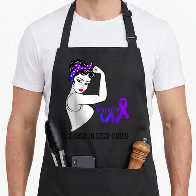 Arthritis warrior awareness ribbon apron - Cartoon woman flexing arm with purple ribbon and text choose to keep going — shown on a black cotton canvas apron against a white background