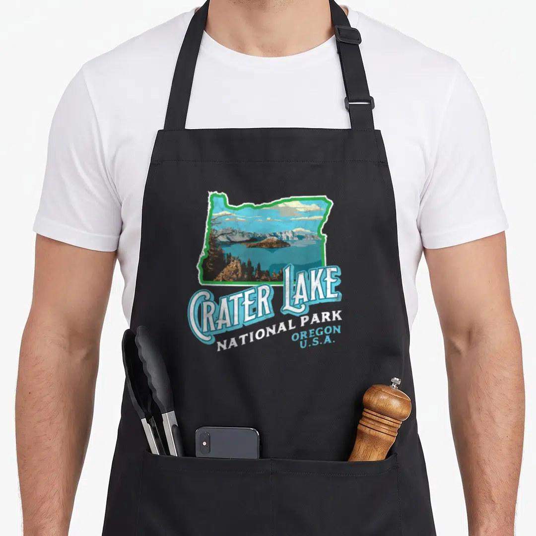 National crater lake apron - Retro Oregon state silhouette containing Crater Lake landscape with stacked blue and white — shown on a black cotton canvas apron against a white background