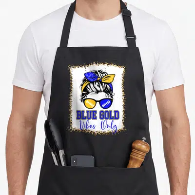 Blue leopard print apron - Cartoon woman bun sunglasses football laces BLUE GOLD Vibes Only leopard border blue gold — shown on a black cotton canvas apron against a white background