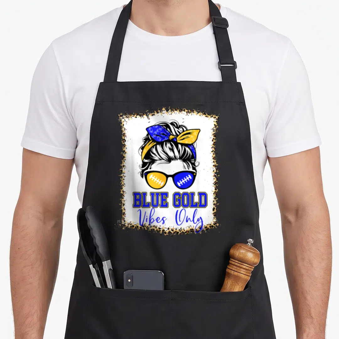 Blue leopard print apron - Cartoon woman bun sunglasses football laces BLUE GOLD Vibes Only leopard border blue gold — shown on a black cotton canvas apron against a white background