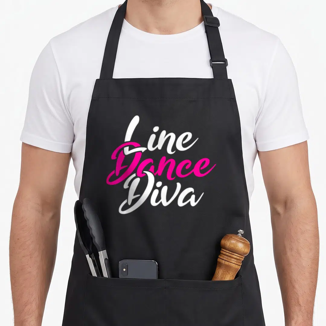 Line country apron - Stacked white and pink script reading Line Dance Diva — shown on a black cotton canvas apron against a white background