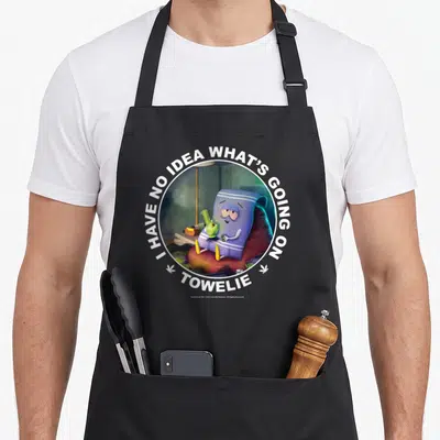 Vintage park apron - Towelie sitting on beanbag with bong, circular text I HAVE NO IDEA WHAT'S GOING ON TOWELIE — shown on a black cotton canvas apron against a white background