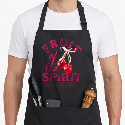 Fruit cherry apron - Red watercolor cherries with pink ribbon and Galatians 5:22-23 text listing virtues — shown on a black cotton canvas apron against a white background