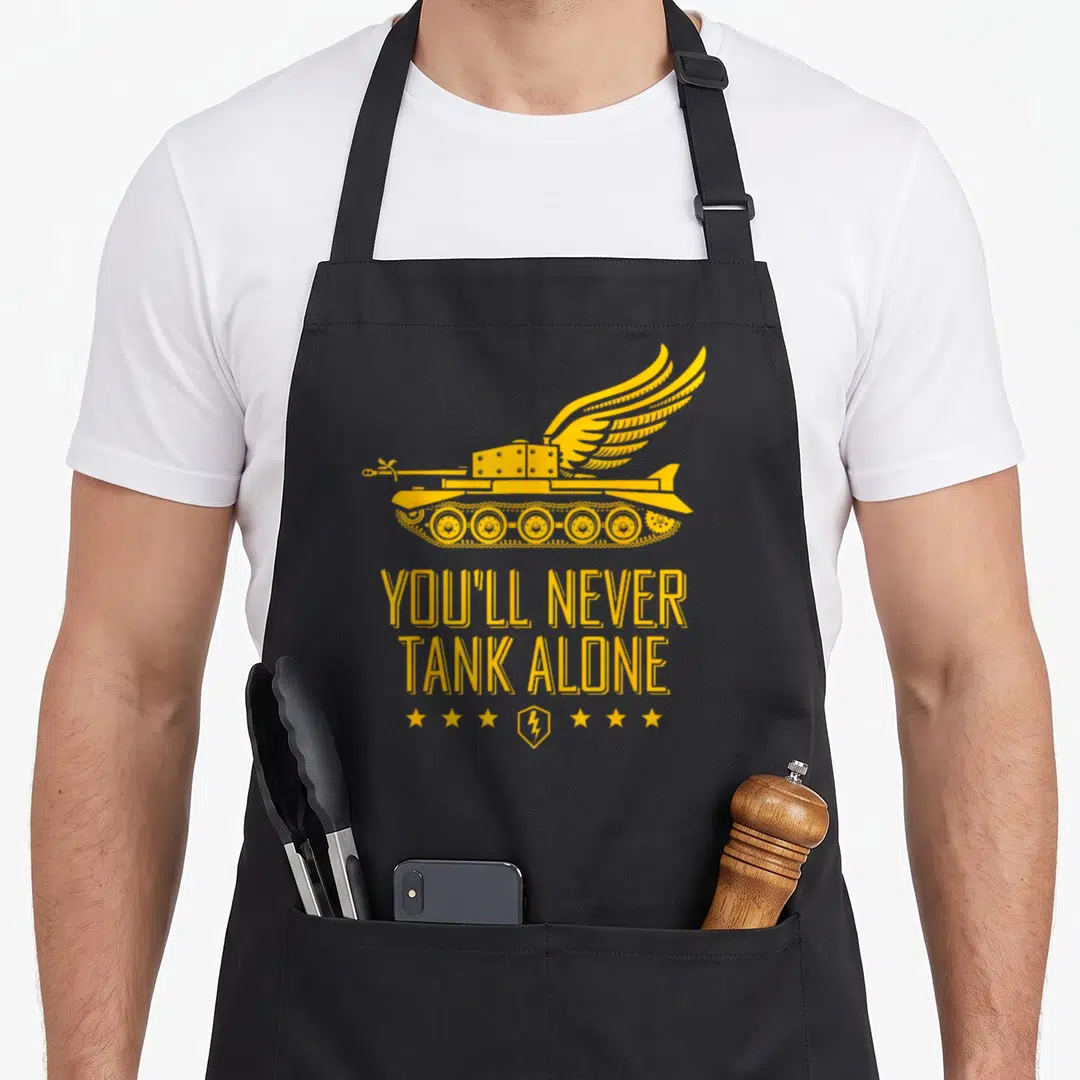 Blitz youll never apron - Yellow winged tank above text and row of stars with lightning bolt emblem — shown on a black cotton canvas apron against a white background