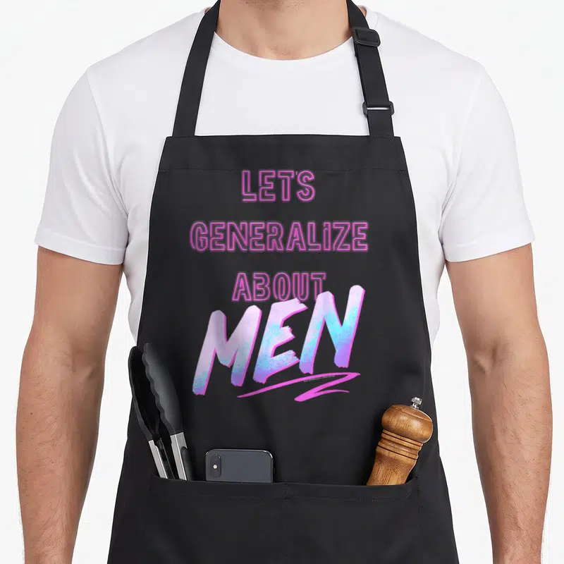 Generalize novelty apron - Stacked pink and blue text reading LET'S GENERALIZE ABOUT MEN on black fabric — shown on a black cotton canvas apron against a white background