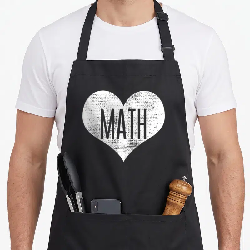 Math student teacher apron - Distressed white heart containing grey MATH text on black background — shown on a black cotton canvas apron against a white background