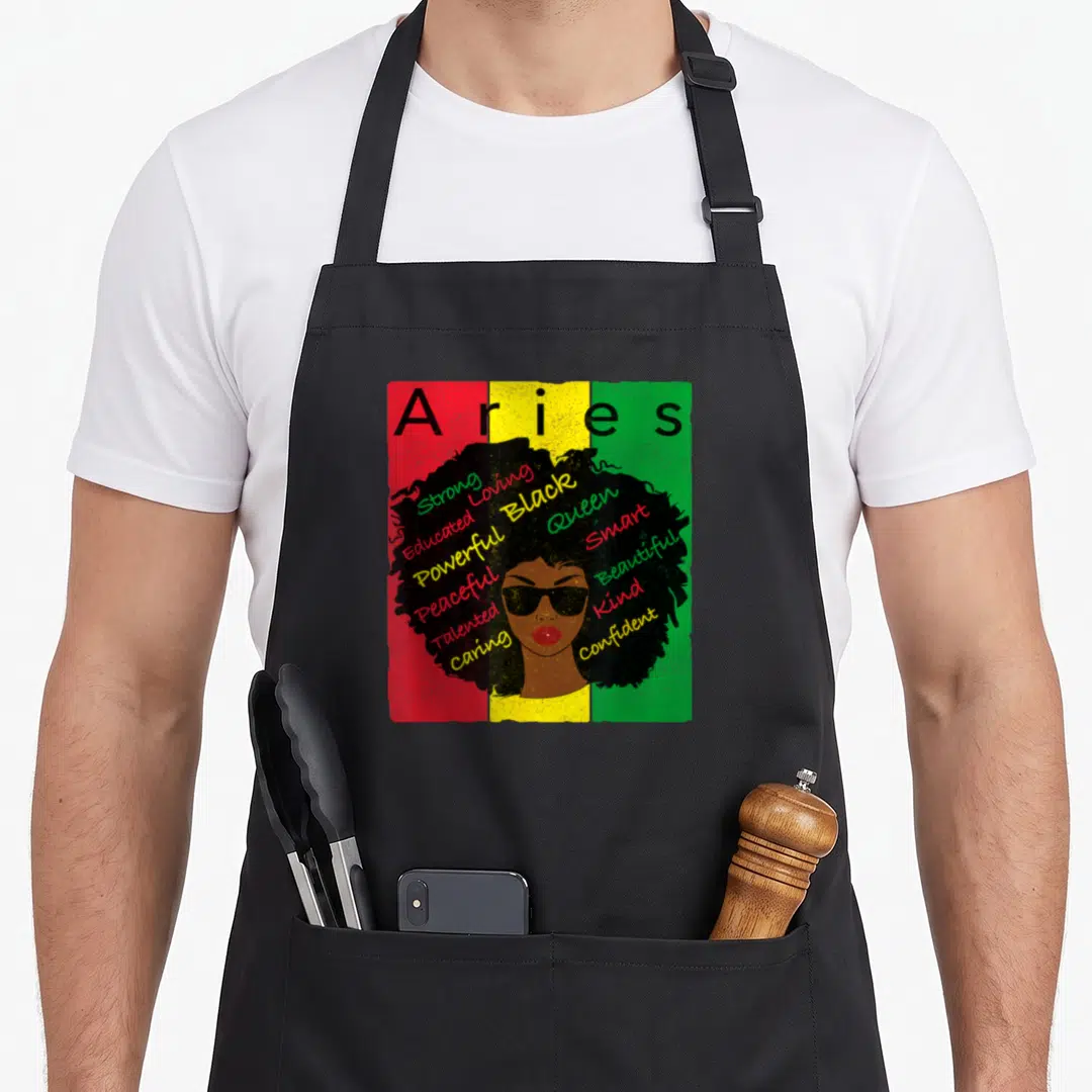 Ary pride apron - Black woman face with words Strong and Queen in afro on red yellow green stripes — shown on a black cotton canvas apron against a white background