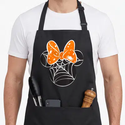 Spider halloween apron - Black mouse head silhouette filled with white spider web and orange bow with white spiders — shown on a black cotton canvas apron against a white background