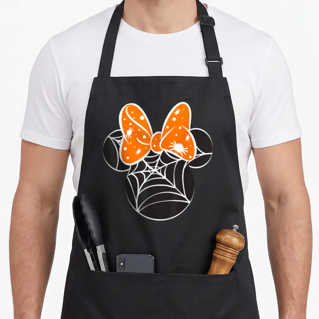 Spider halloween apron - Black mouse head silhouette filled with white spider web and orange bow with white spiders — shown on a black cotton canvas apron against a white background