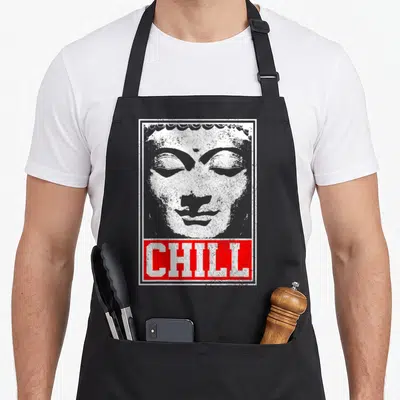 Chill meditation buddhist apron - Distressed grey Buddha head with white border and red CHILL text block overlay — shown on a black cotton canvas apron against a white background