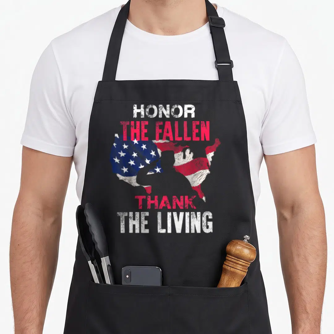 Honor themed aprons - Distressed US map with soldier silhouette and text HONOR THE FALLEN THANK THE LIVING in red — shown on a black cotton canvas apron against a white background