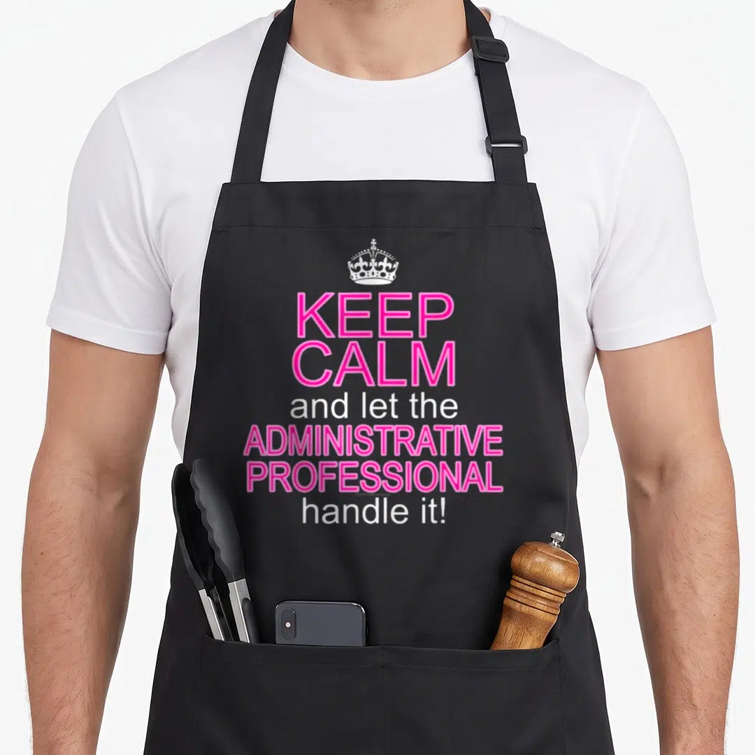 Administrative assistant professional aprons - White crown above pink and white text reading KEEP CALM and let — shown on a black cotton canvas apron against a white background