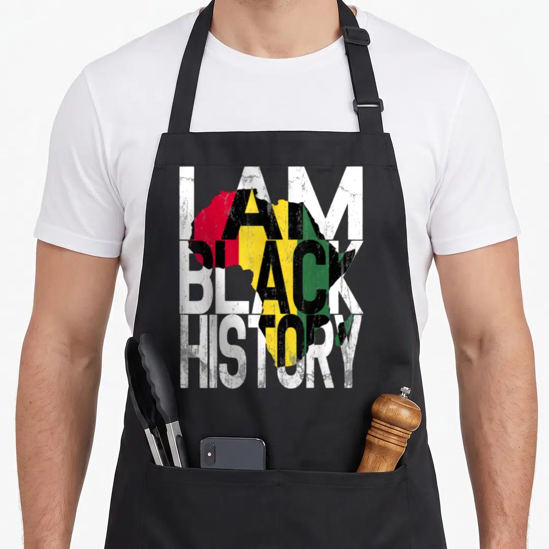 Month african print apron - I Am Black History text over distressed map of Africa in red yellow green and black — shown on a black cotton canvas apron against a white background