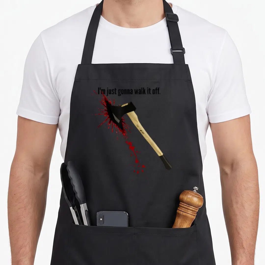 Axe bloody apron - Realistic axe with red splatter and text I'm just gonna walk it off — shown on a black cotton canvas apron against a white background