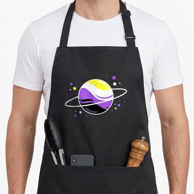 Nonbinary pride apron - Minimalist planet with ring in yellow white purple and black flag colors surrounded by stars — shown on a black cotton canvas apron against a white background
