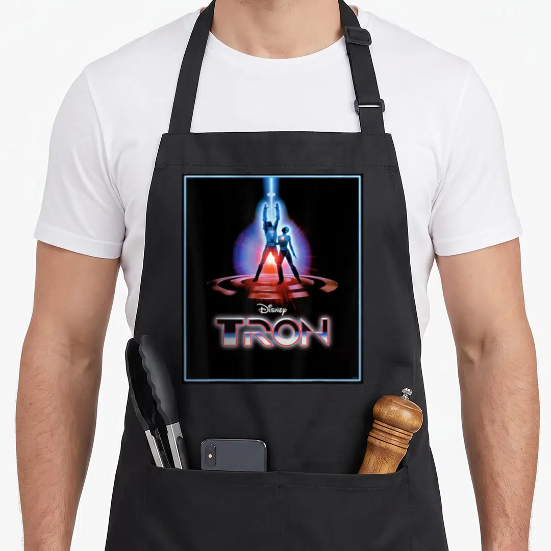 Original movie poster apron - TRON logo and characters on circular platform under light beam with blue border — shown on a black cotton canvas apron against a white background