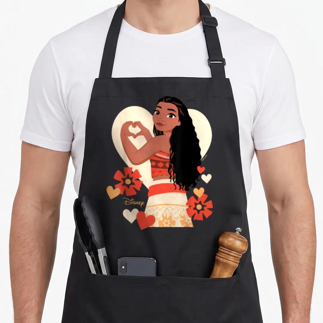 Funny princess valentine's day apron - Woman making heart shape with hands, red flowers, cream heart background, Disney — shown on a black cotton canvas apron against a white background