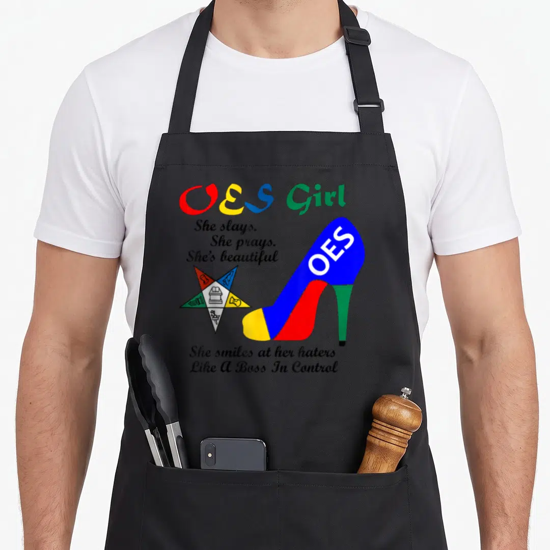 Heel beautiful apron - Colorful high heel shoe and five-pointed star with OES Girl text — shown on a black cotton canvas apron against a white background