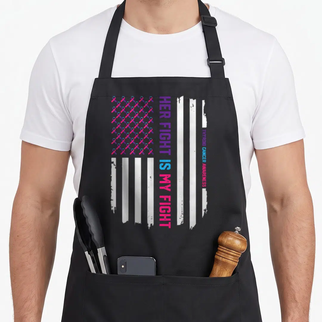 Flag thyroid apron - Distressed flag with pink purple blue ribbons and vertical Her Fight Is My Fight text — shown on a black cotton canvas apron against a white background