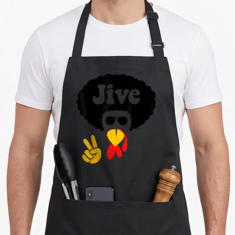 Peace thanksgiving apron - Stylized person with black afro Jive text, sunglasses, yellow peace hand, red collar — shown on a black cotton canvas apron against a white background