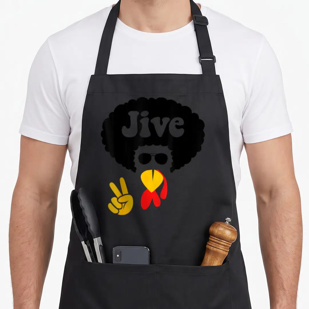 Peace thanksgiving apron - Stylized person with black afro Jive text, sunglasses, yellow peace hand, red collar — shown on a black cotton canvas apron against a white background